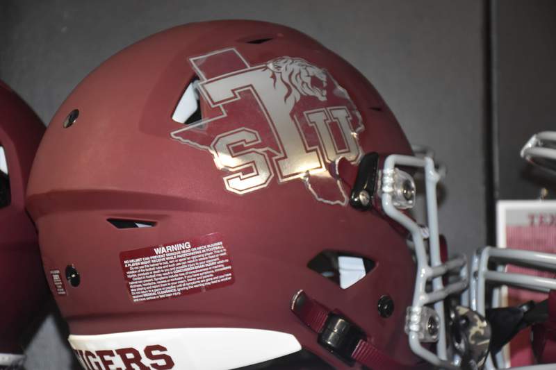 Texas Southern University alum Michael Strahan donates football helmets to players