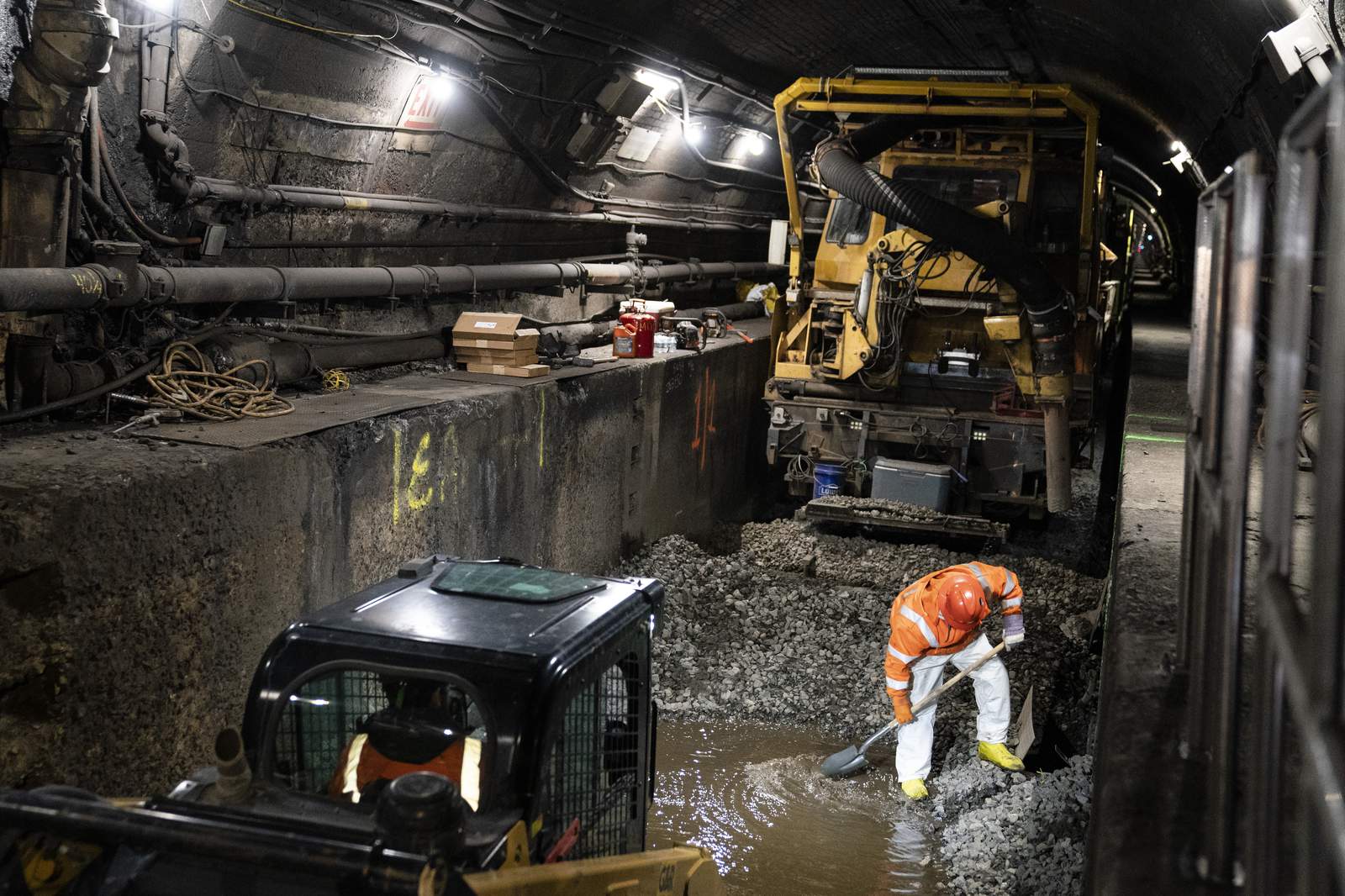 In a leaky underwater rail tunnel, workers race against time