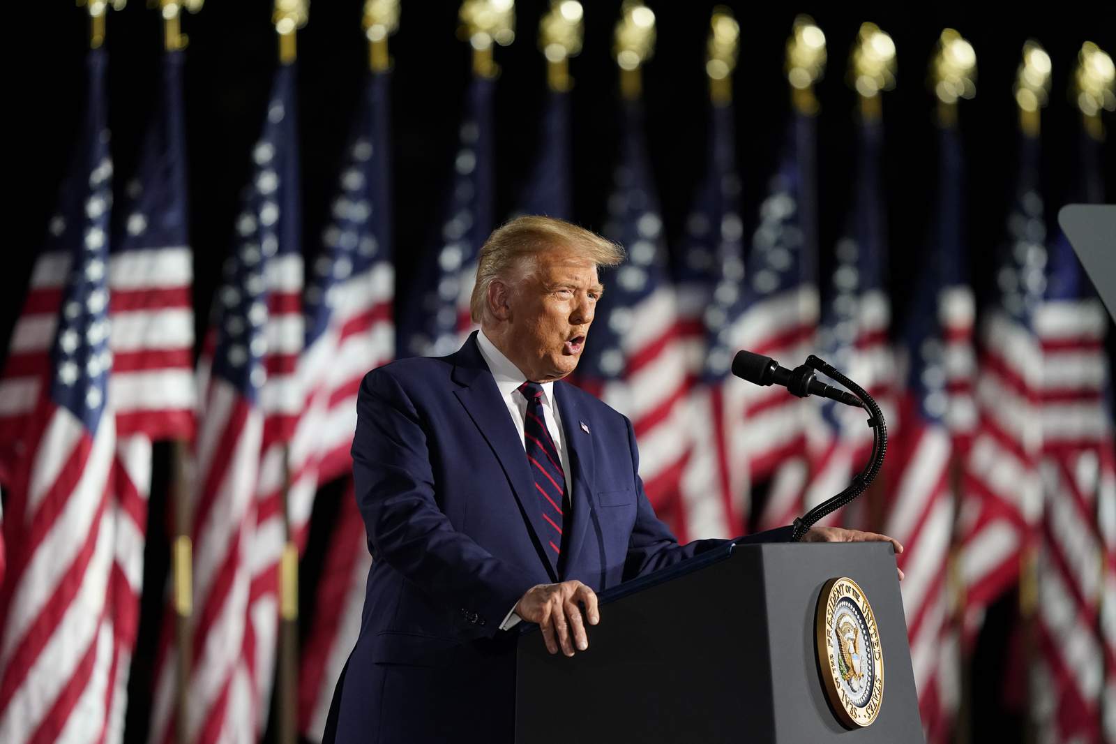 Trump lashes Biden, defies pandemic on White House stage