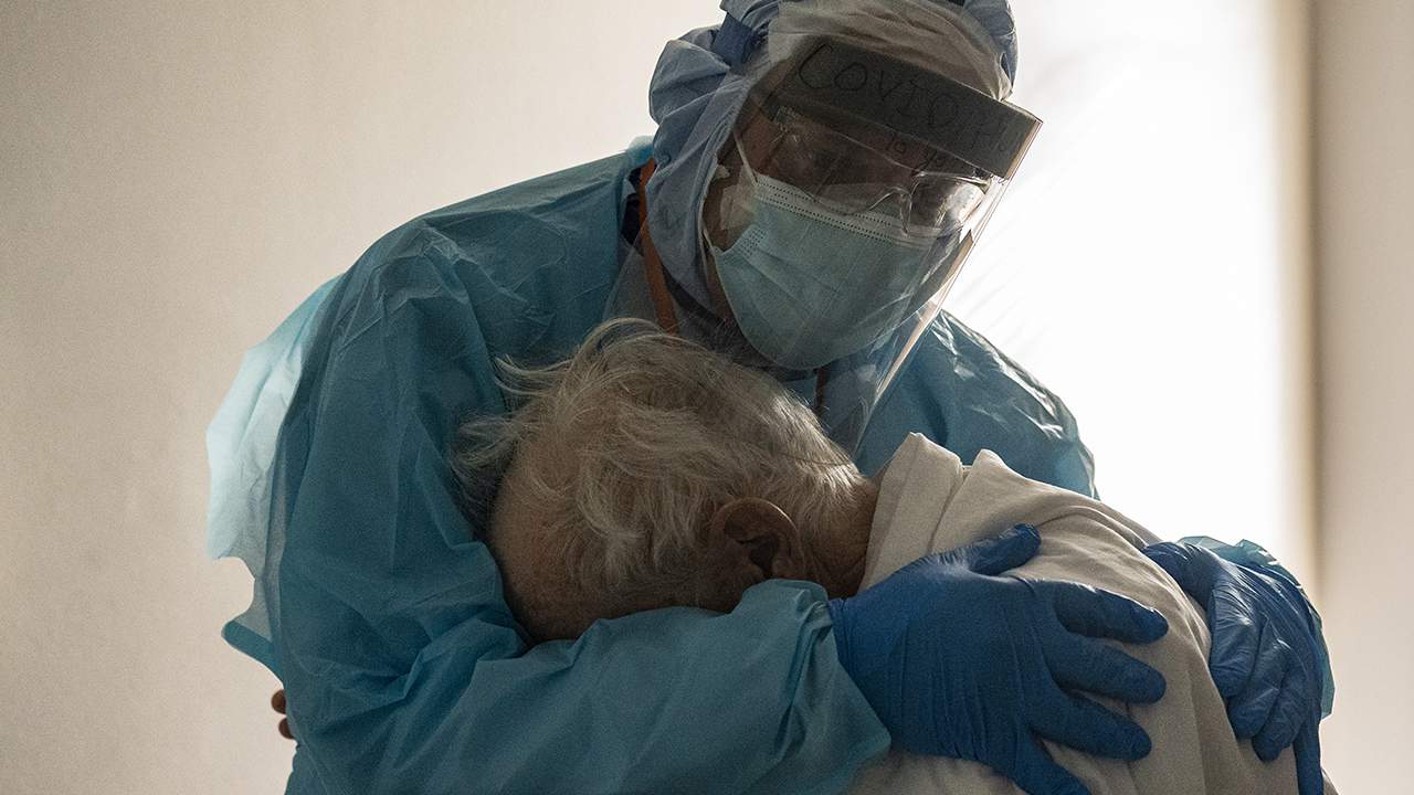 FILE - Dr. Joseph Varon hugs and comforts a patient in the COVID-19 intensive care unit (ICU) during Thanksgiving at the United Memorial Medical Center on November 26, 2020 in Houston, Texas. According to reports, Texas has reached over 1,220,000 cases, including over 21,500 deaths.