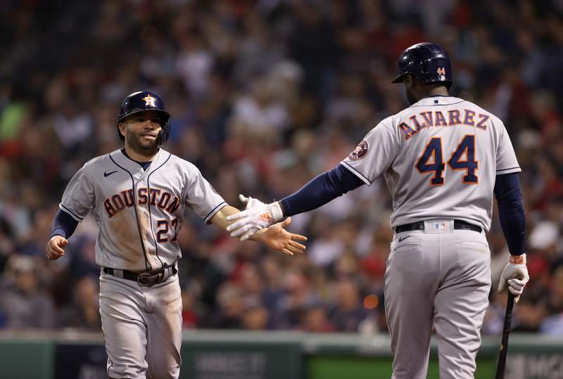 BOSTON, MASSACHUSETTS - OCTOBER 20: Jose Altuve #27 of the Houston Astros is congratulated by Yordan Alvarez #44 after he scored against the Boston Red Sox in the seventh inning of Game Five of the American League Championship Series at Fenway Park on October 20, 2021 in Boston, Massachusetts. (Photo by Elsa/Getty Images)