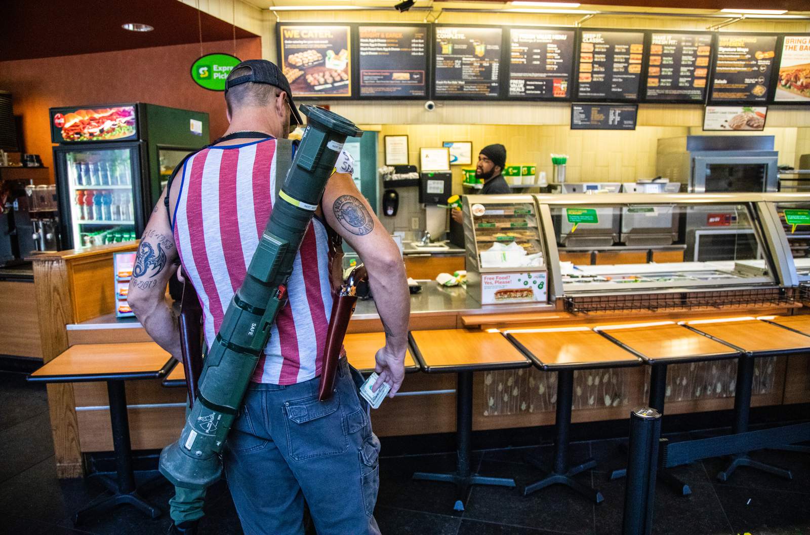 Photos of protesters carrying a rocket launcher, shotguns, and pistols while at a Subway restaurant go viral