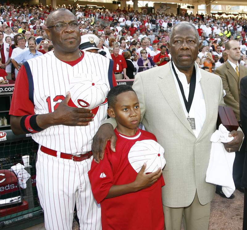 Cincinnati Reds manager Dusty Baker, left, stands with his son Darren Baker, center, and baseball great Hank Aaron, right, as the national anthem plays during the Civil Rights Game ceremony before a game between the Chicago White Sox and the Cincinnati Reds at Great American Ball Park, Saturday, June 20, 2009, in Cincinnati. (AP Photo/David Kohl)