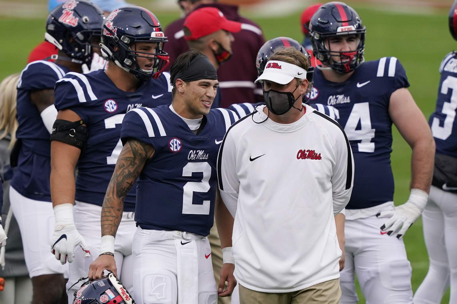 The Latest: Mississippi pauses football activities thru Wed