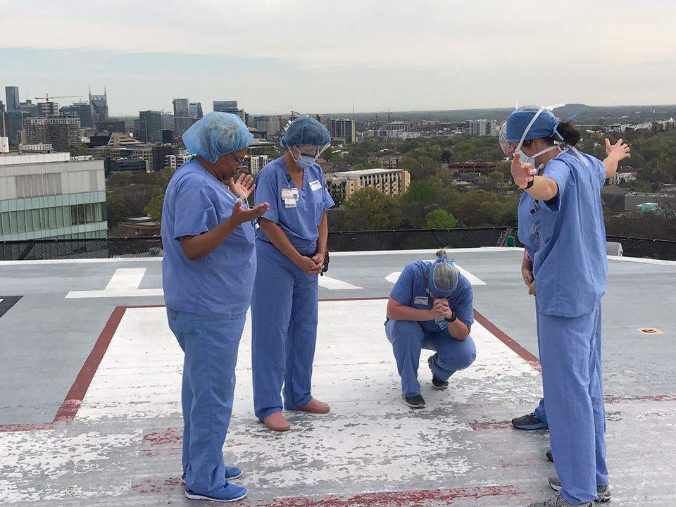 Nurses gather on hospital helipad to pray together before work