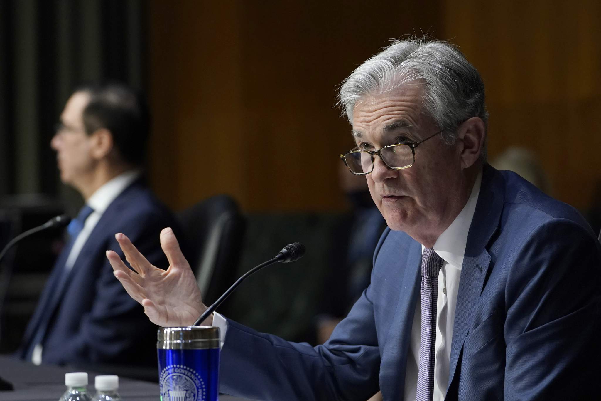 Powell says economy recovering but Fed support still needed