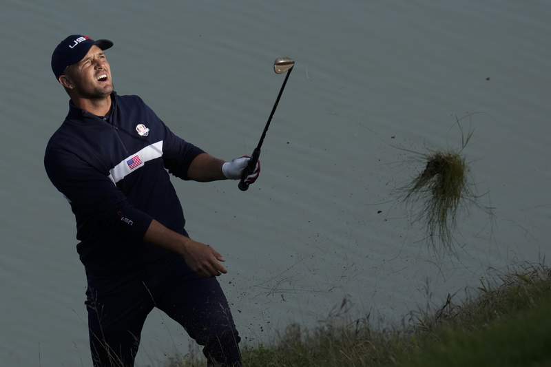 The Latest: DeChambeau drives green, makes eagle on first