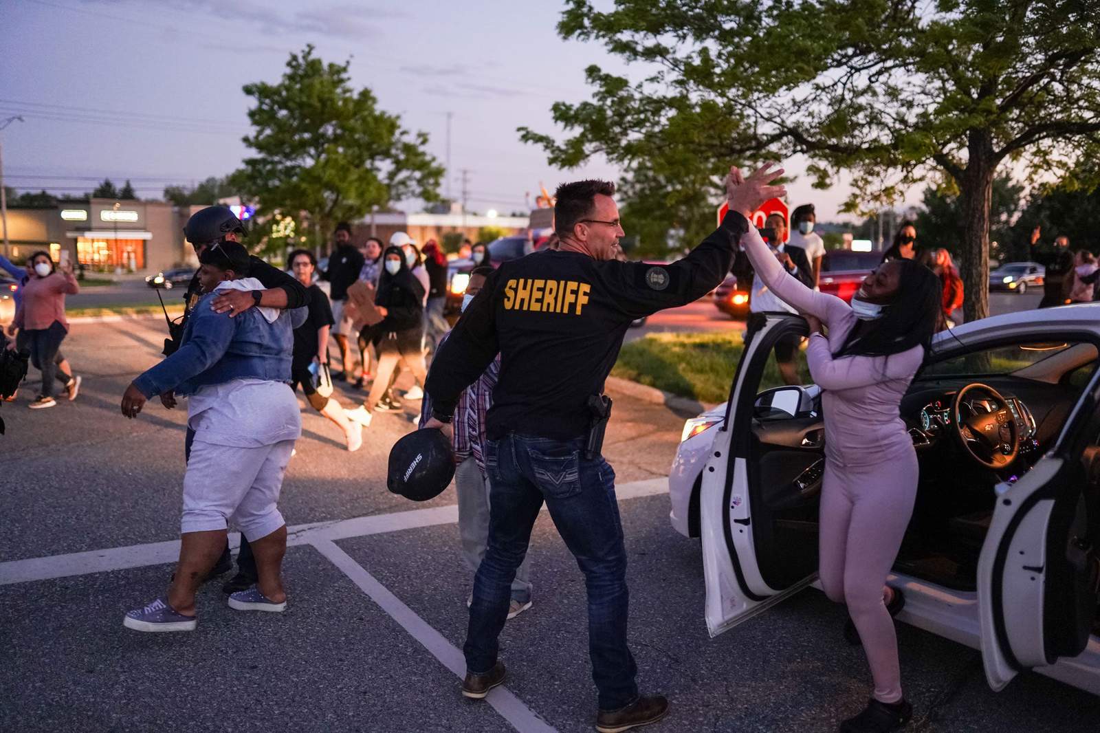 A sheriff put down his baton to listen to protesters. They chanted walk with us, so he did.