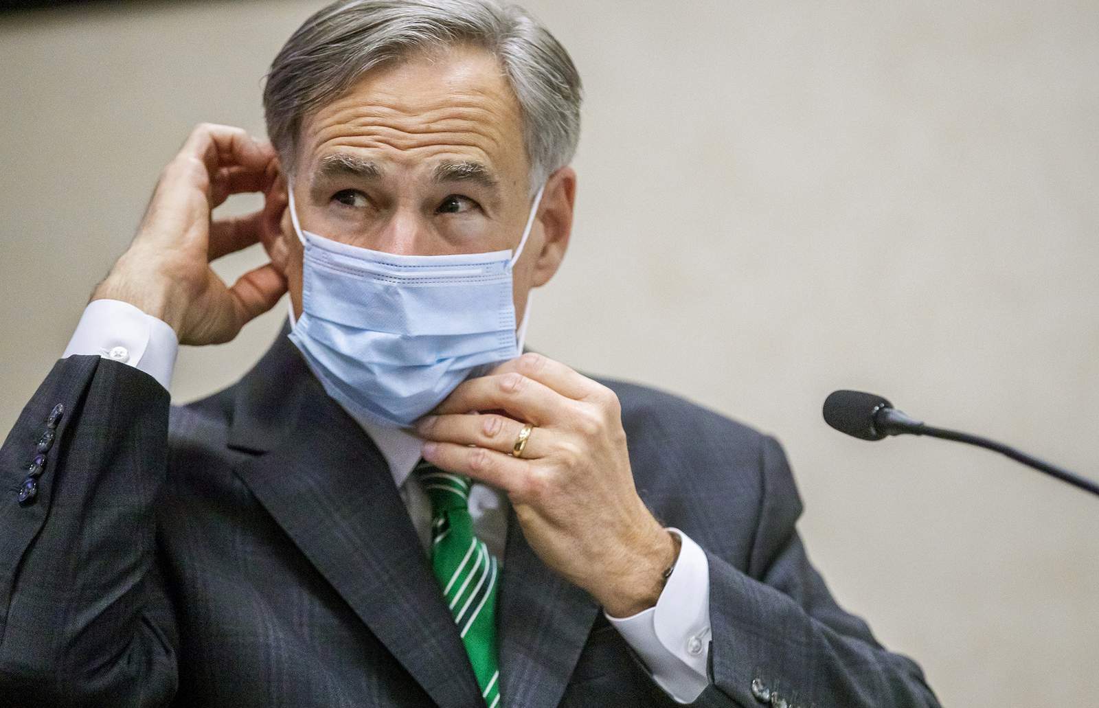 CORRECTS CITY TO AUSTIN, INSTEAD OF HOUSTON Texas Gov. Greg Abbott adjusts his mask after giving an update on the categories of medical surge facilities and how it effects Level 5 of maintaining staffed beds during a press conference at Texas Department of Public Safety, Tuesday, June 16, 2020, in Austin, Texas. (Ricardo B. Brazziell/Austin American-Statesman via AP)