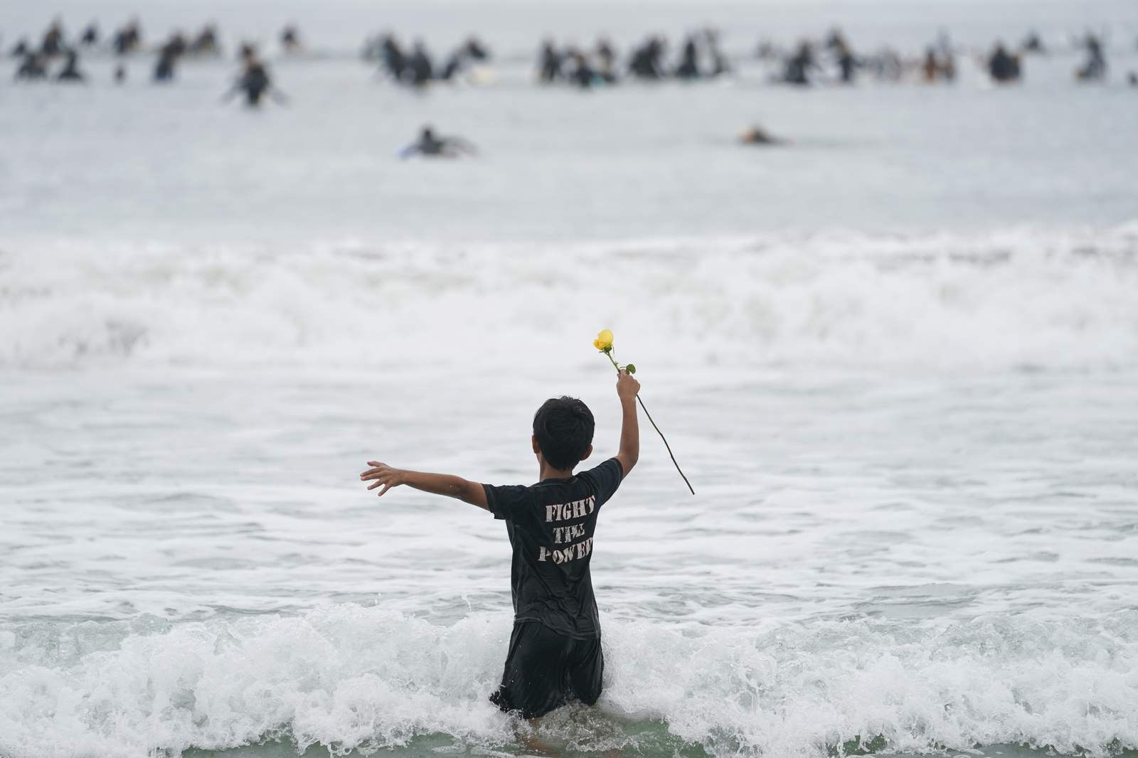 Surfers 'paddle out,' circle up in memory of George Floyd
