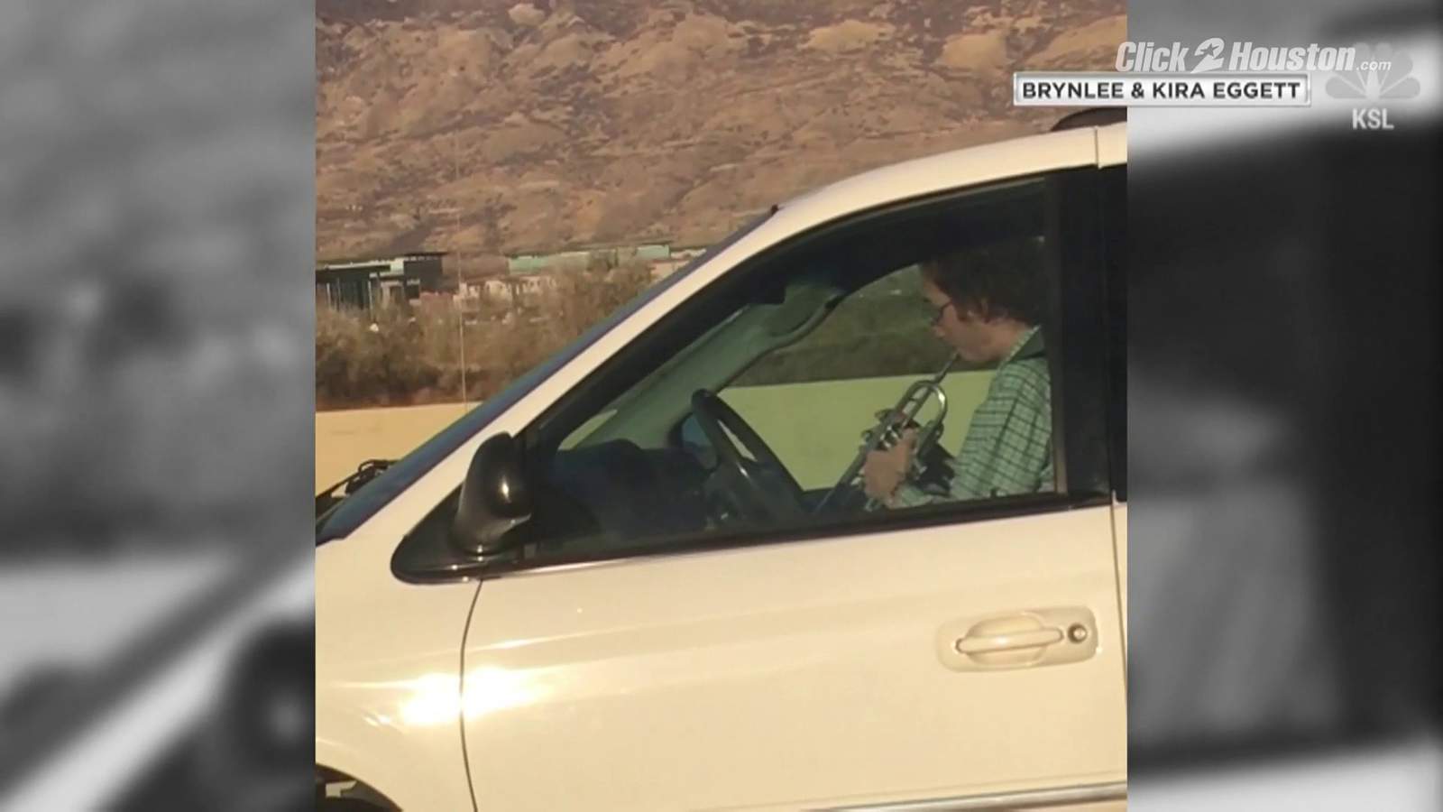 Distracted driver spotted playing trumpet behind the wheel