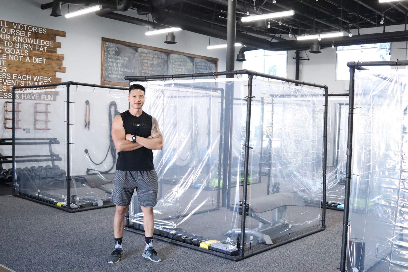 A gym is using plastic pods to help members maintain social distancing during workouts