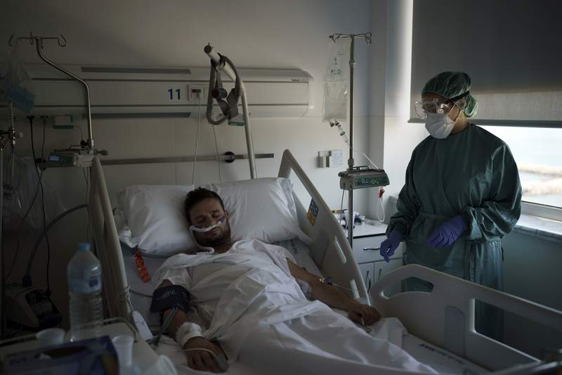 New virus surge sends younger patients to Spain's hospitals