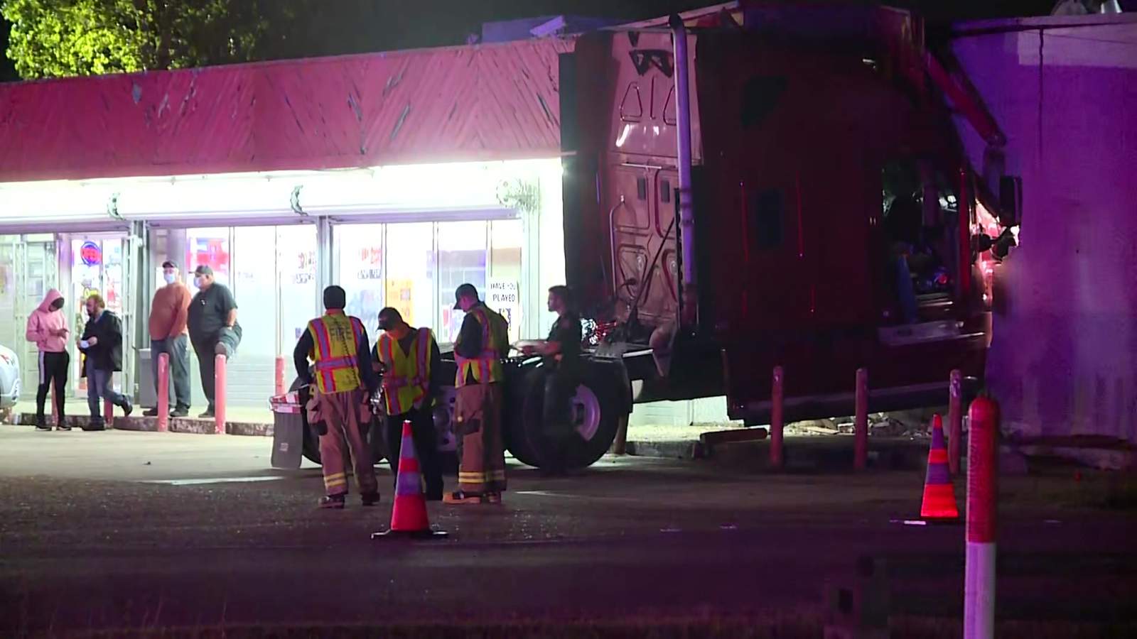 WATCH: Big rig cab slams into store after head-on crash with another big rig