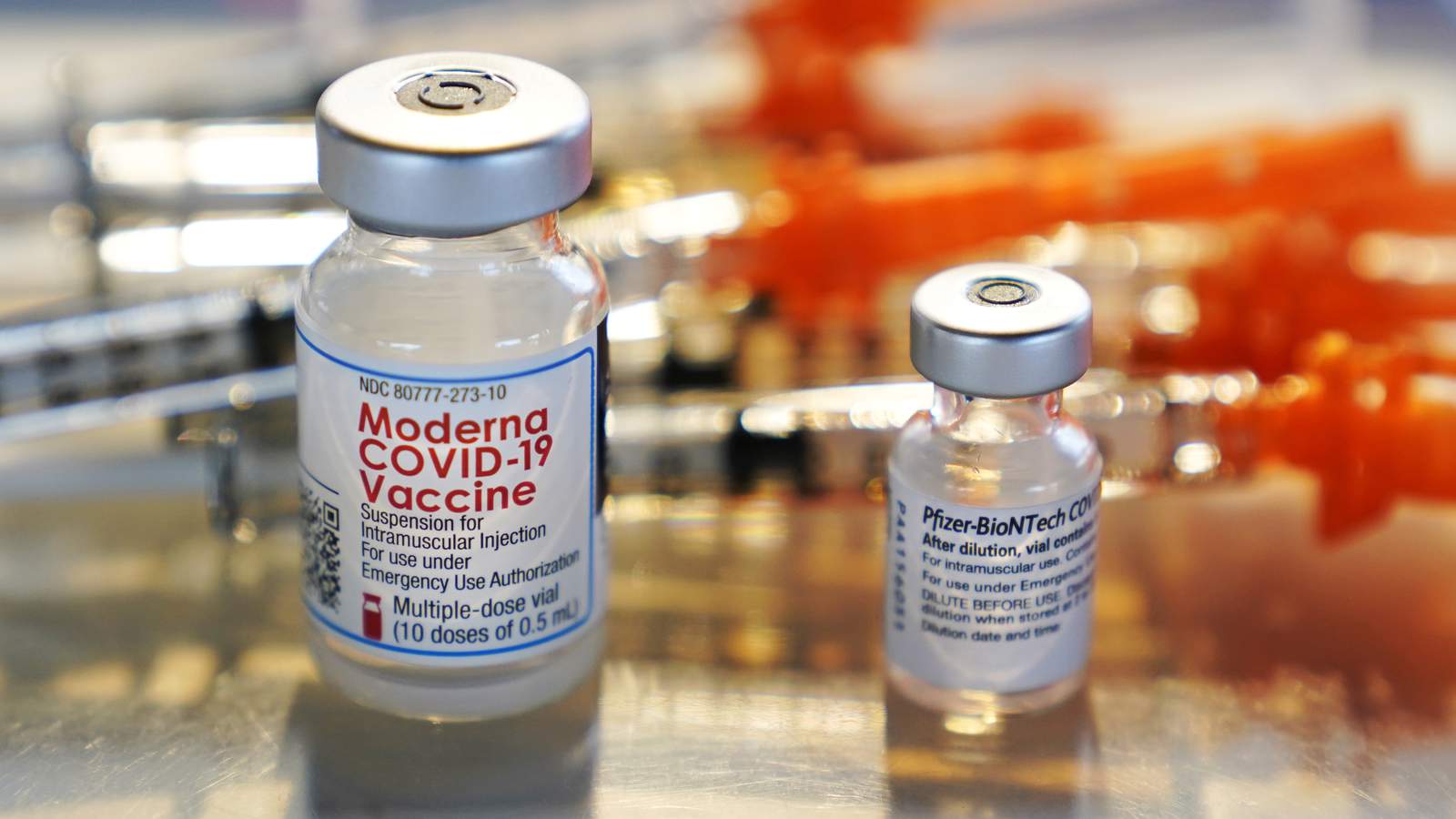 FILE - In this Feb. 25, 2021, file photo, vials for the Moderna and Pfizer COVID-19 vaccines are displayed on a tray at a clinic set up by the New Hampshire National Guard in the parking lot of Exeter, N.H., High School. (AP Photo/Charles Krupa, File)