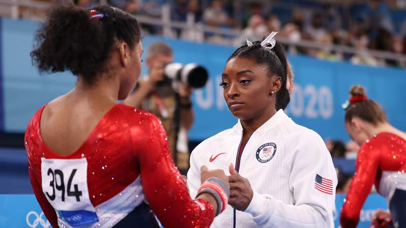 Simone Biles encourages teammate Jordan Chiles during the team final of the women's artistic gymnastics competition in Tokyo. Biles only competed on the vault and will not compete on other events.