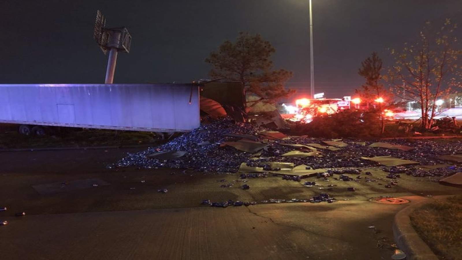 Driver of 18-wheeler killed, load of empty beer cans spilled on North Freeway