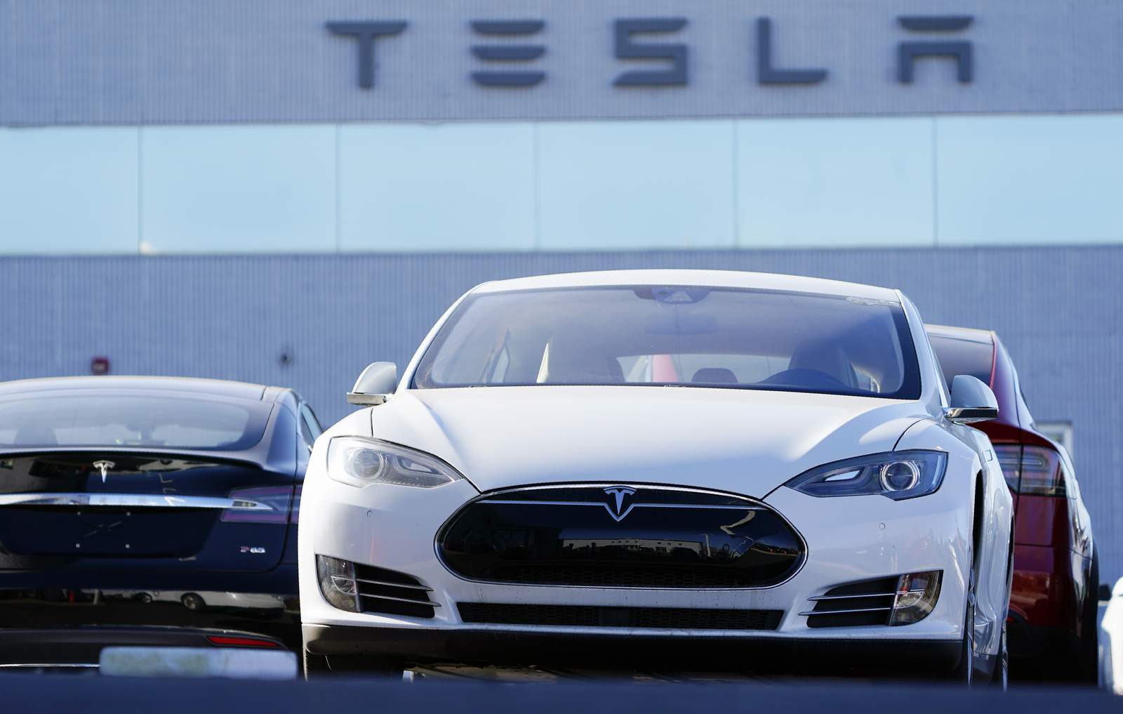 High-flying Tesla stock takes a hit on 1st day in S&P 500